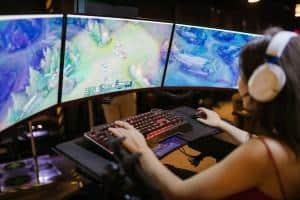 Girl Playing Games on Multi screen setup PC