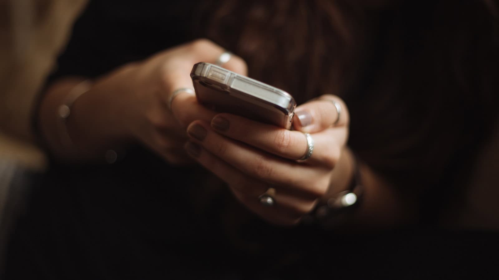 Hand holding and using a smartphone