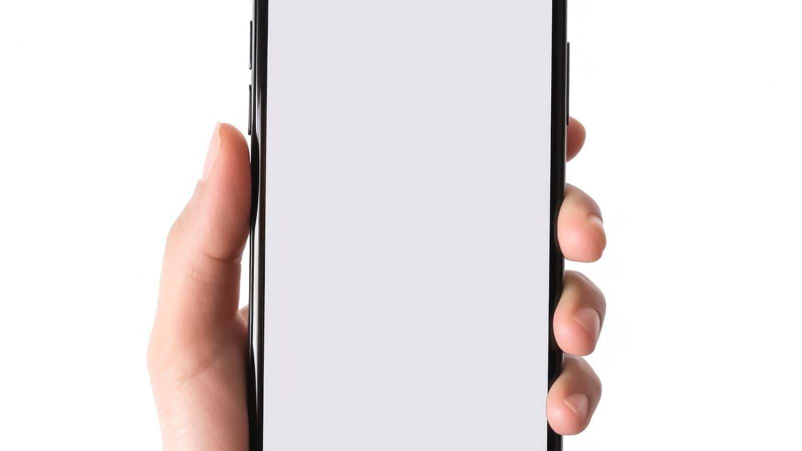 Hand holding a smartphone with a blank screen
