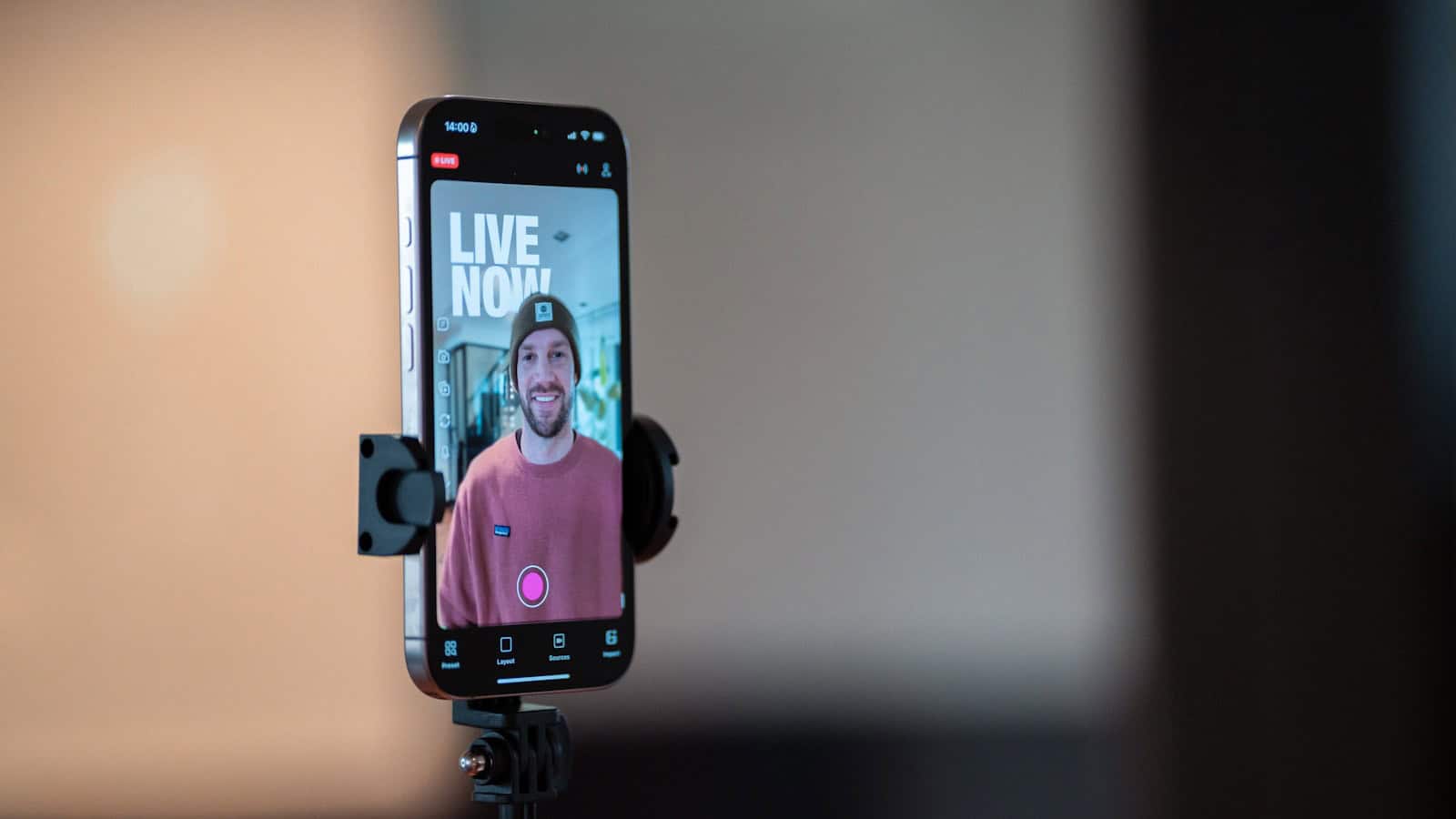 Smartphone on a tripod displaying a live broadcast