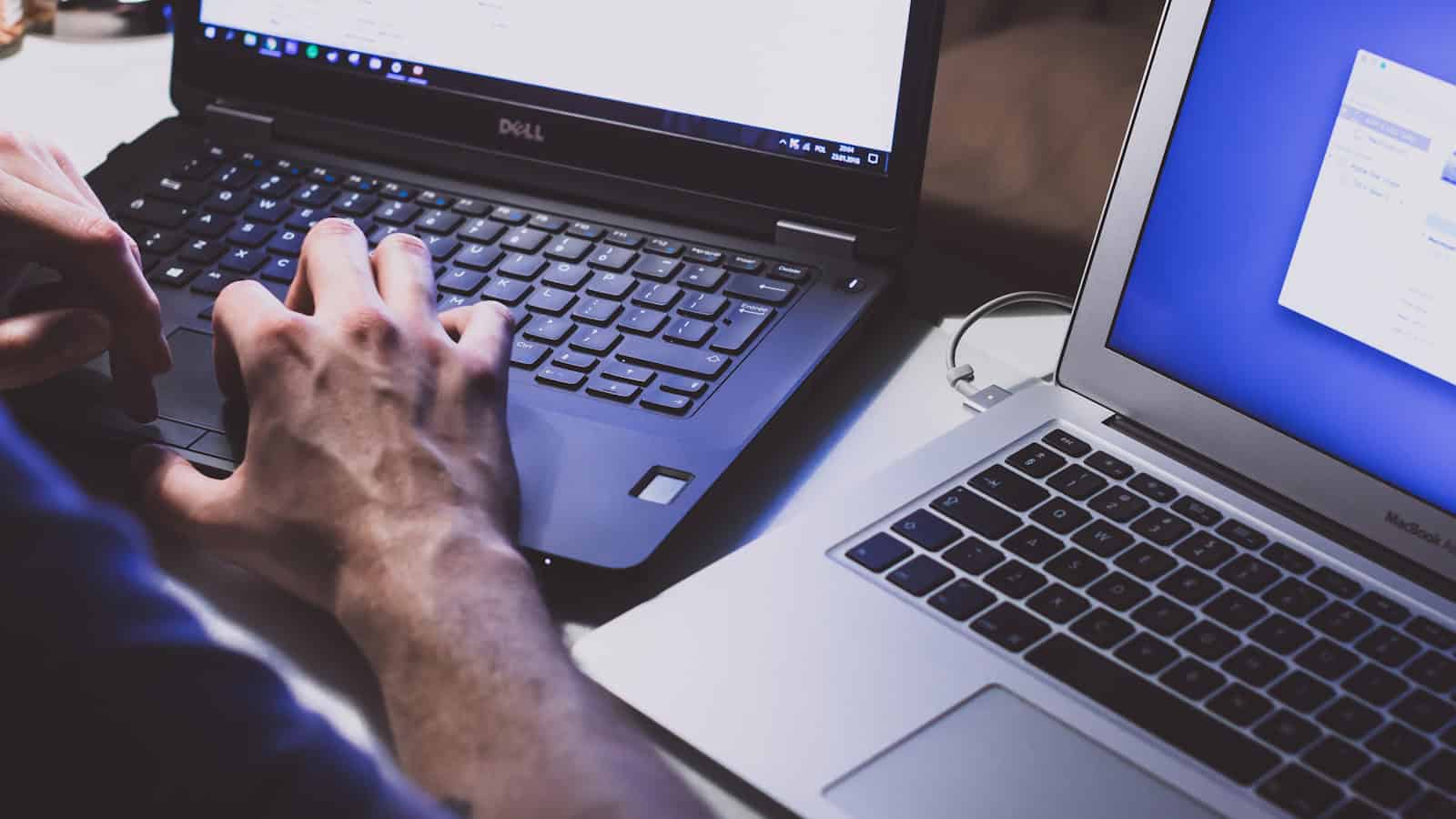 Windows laptop and MacBook side by side on a desk