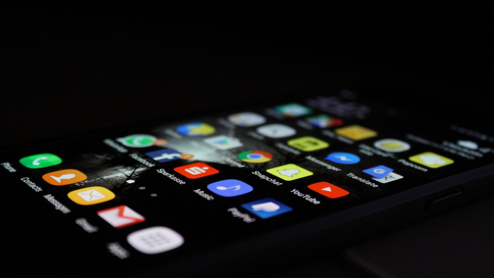 A close angled view of an Android app drawer, rows of app icons filling a dark phone screen.