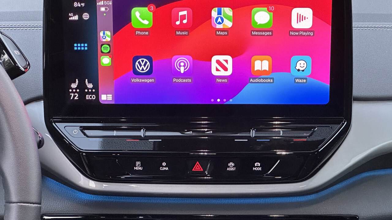 A car's dashboard touchscreen running Apple CarPlay, showing the CarPlay app grid with Phone, Maps, Messages and Music