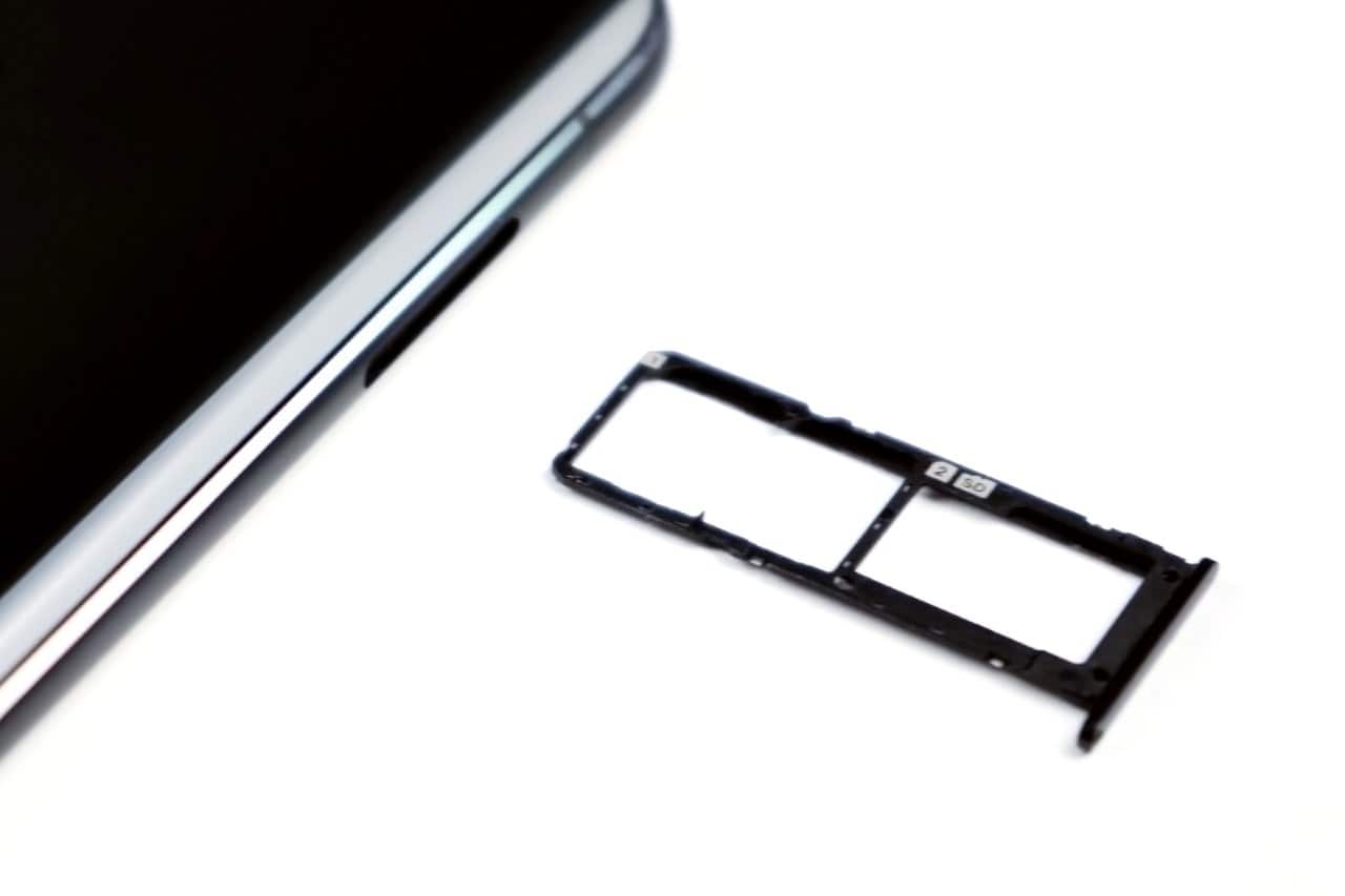 An Android dual-SIM tray removed from a phone, showing the second SIM and microSD slots empty.