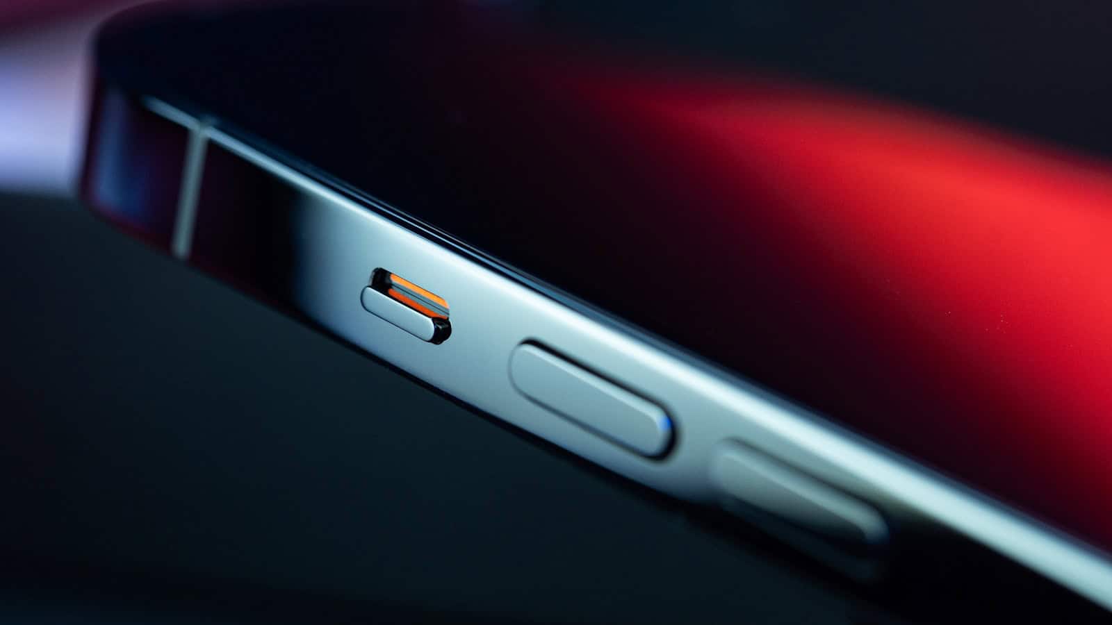 A close view of the bottom edge of a phone showing the charging port and the speaker holes beside it.