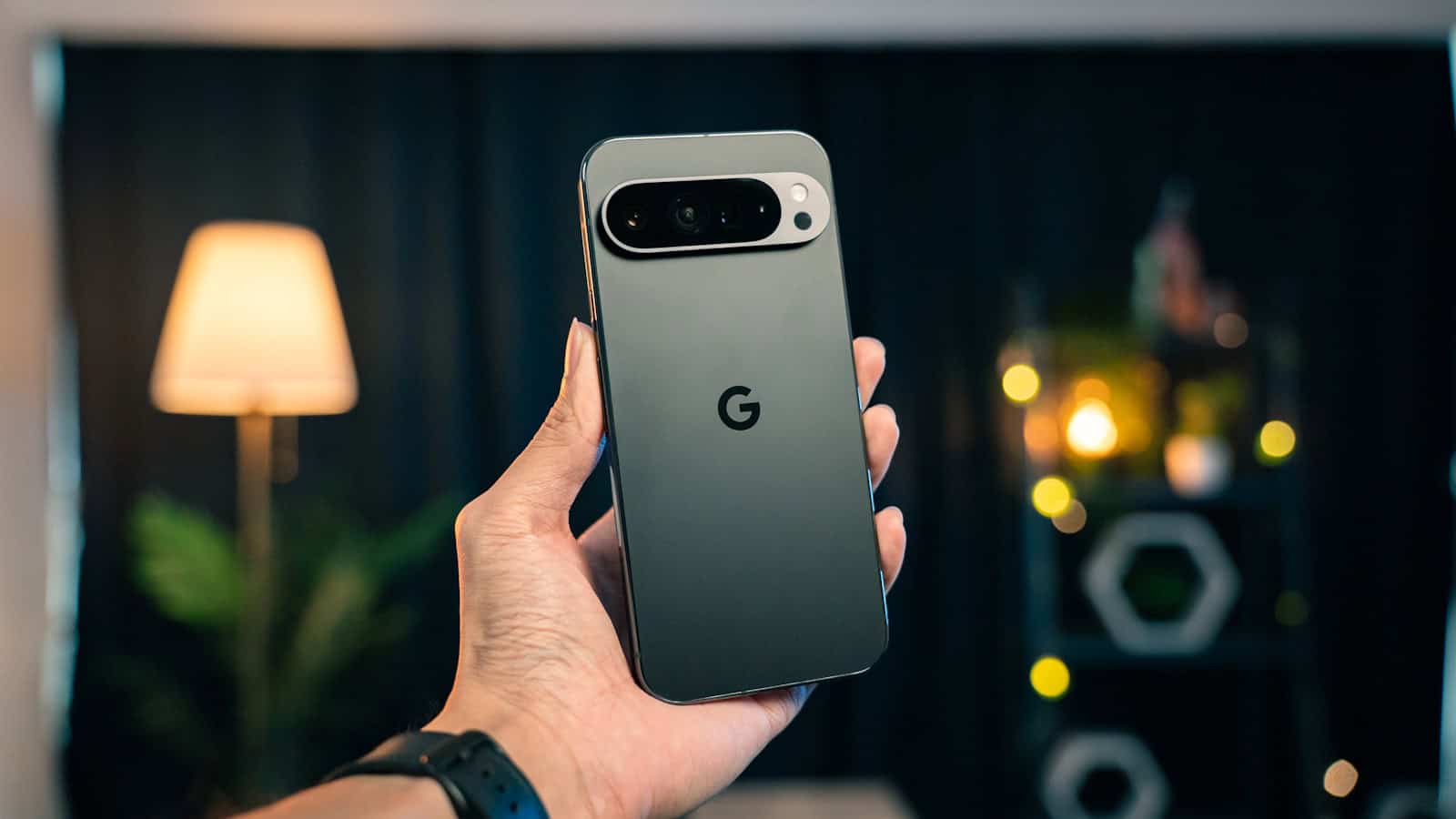 A hand holding a Google Pixel phone from behind, showing its camera bar and G logo.