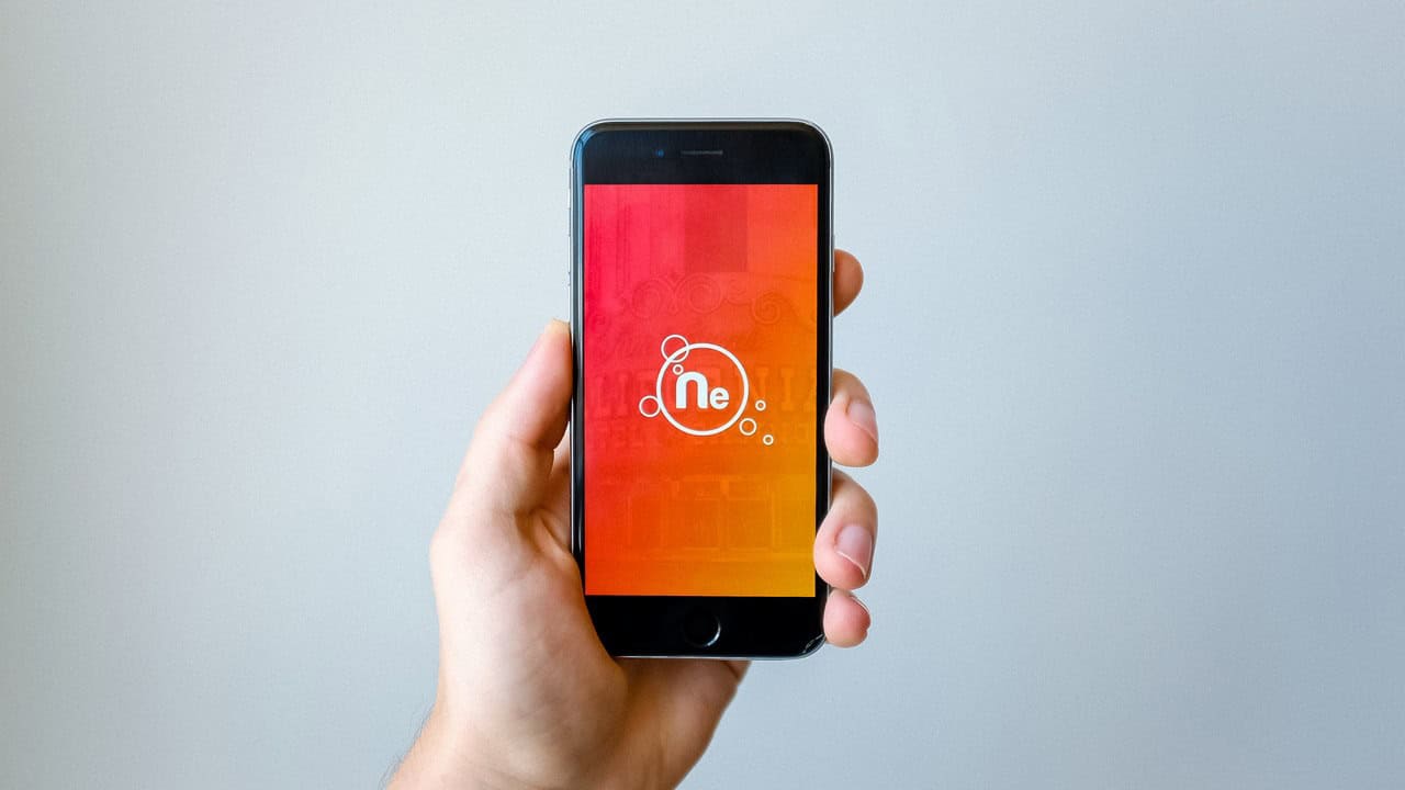 A hand holding a modern smartphone.
