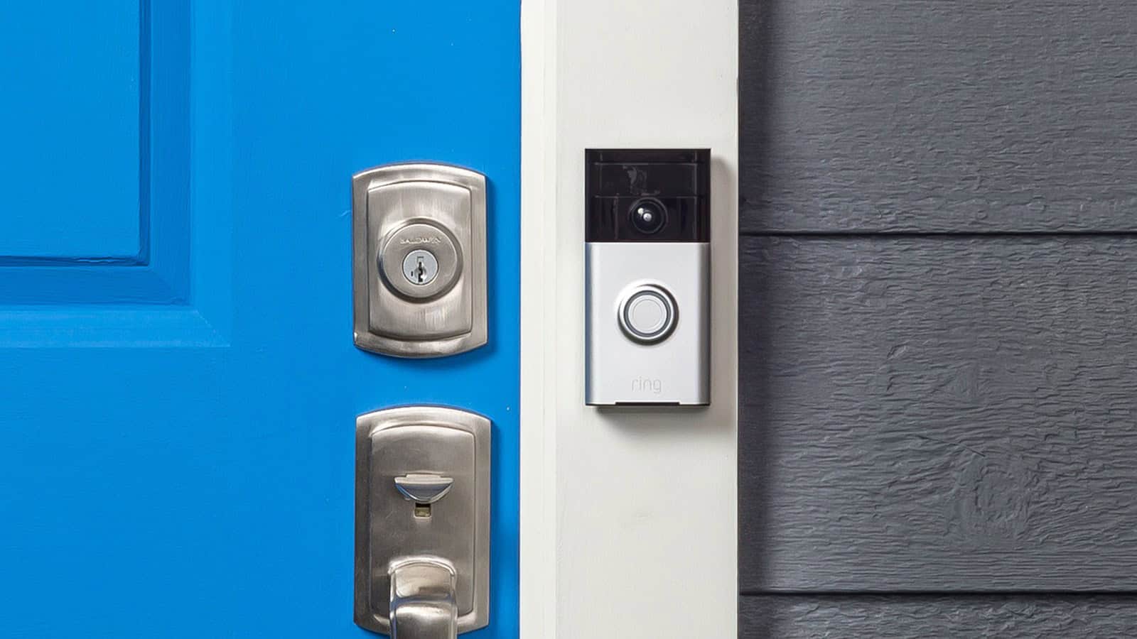 Ring video doorbell mounted beside a blue front door