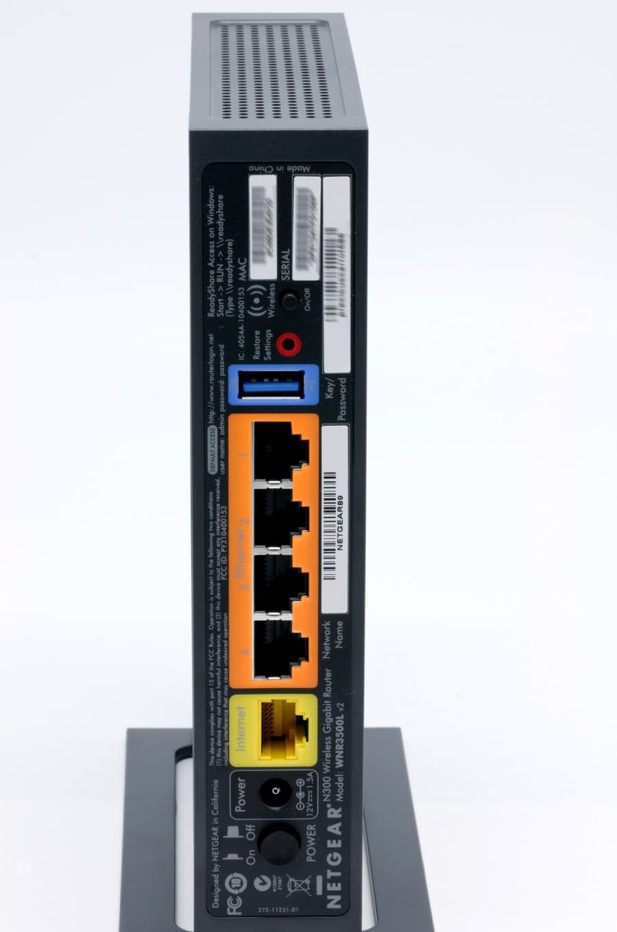 Rear panel of a Netgear home router showing the Ethernet ports, power socket and recessed reset button.
